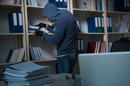 Young man in industrial espionage conceptの写真素材