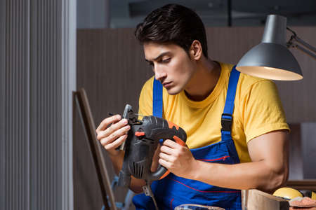 Worker working in repair workshop in woodworking conceptの写真素材