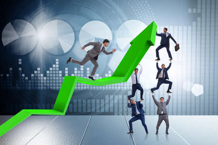 Businessman supporting growtn in economy on chart graphの写真素材