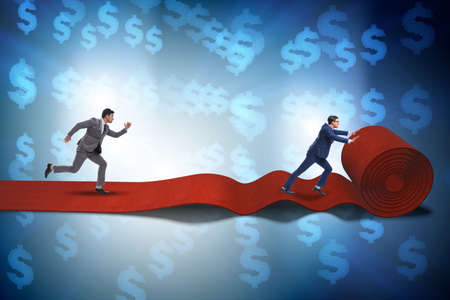 Businessman with dollars on red carpetの写真素材