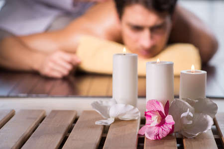 Young handsome man during spa procedure