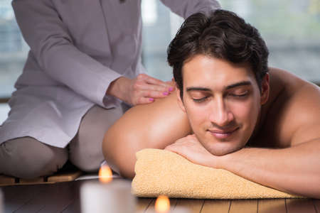 Young handsome man during spa procedureの写真素材