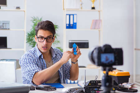 Vlogger recording computer repair on camera for vlog blogの写真素材