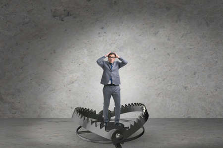 Man caught in mouse trap in risk business conceptの写真素材
