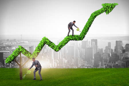 Businessman in investment concept watering financial line chartの写真素材