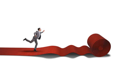 Businessman on red carpet isolated white backgroundの写真素材