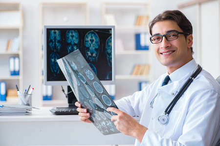 Doctor radiologist looking at x-ray imagesの写真素材