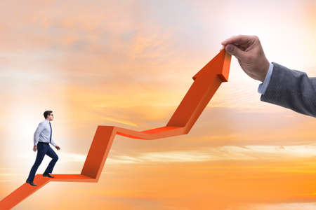 Businessman supporting growtn in economy on chart graphの写真素材