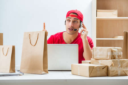 Call center worker at parcel distribution center in post officeの写真素材
