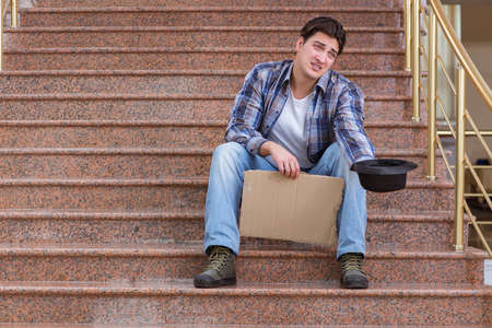 Young man begging money on the streetの写真素材