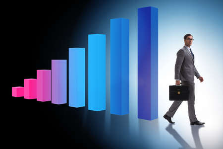 Young businessman in business concept with bar chartsの写真素材