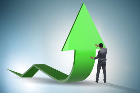 Businessman supporting growtn in economy on chart graphの写真素材