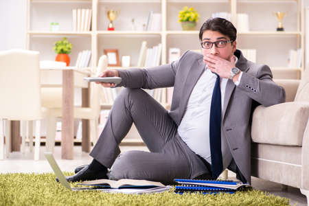 Businessman working on the floor at homeの写真素材