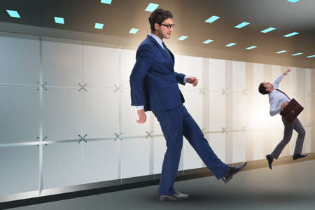 Bad angry boss kicking employee in business conceptの写真素材