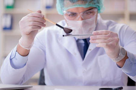 Forensics investigator working in lab on crime evidenceの写真素材