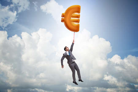 Businessman flying on euro sign inflatable balloonの写真素材