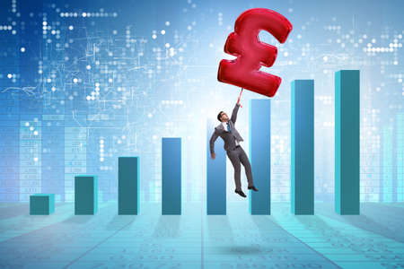 Businessman flying on british pound sign inflatable balloonの写真素材