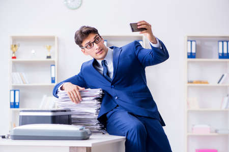 Businessman making copies in copying machineの写真素材