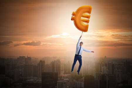 Businessman flying on euro sign inflatable balloonの写真素材