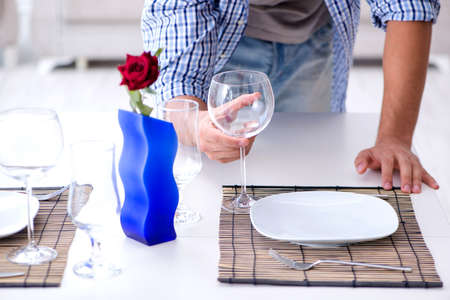 Man alone preparing for romantic date with his sweetheartの写真素材