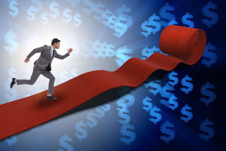 Businessman with dollars on red carpetの写真素材