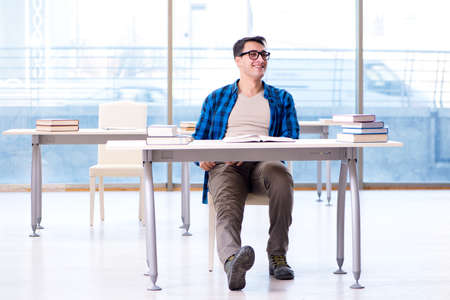 Student studying in the empty library with book preparing for exの写真素材
