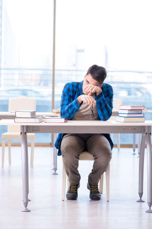 Student studying in the empty library with book preparing for exの写真素材