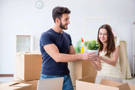 Young family unpacking at new house with boxes