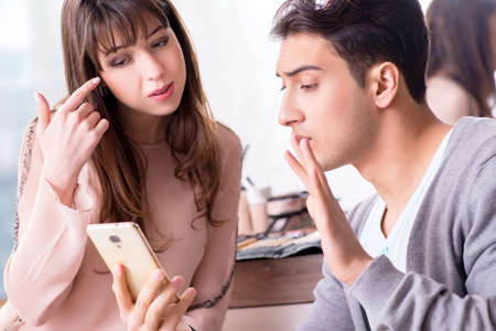 Man doing make-up for cute woman in beauty salon