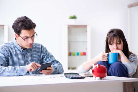 Young couple looking at family finance papers