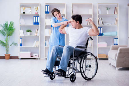 Patient undergoing rehabilitation recovery programme with doctorの写真素材