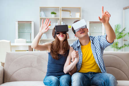Young family playing games with virtual reality glasses
