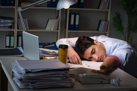 Employee relieving stress from overtime with drugs narcoticsの写真素材