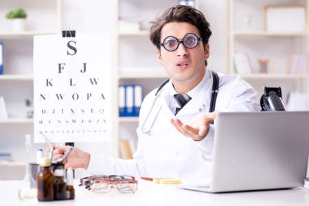 Funny eye doctor in humourous medical conceptの写真素材