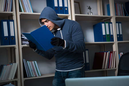 Young man in industrial espionage conceptの写真素材