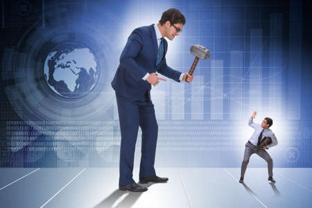 Bad angry boss threatening employee with hammerの写真素材