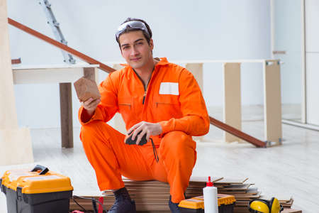 Contractor working on laminate wooden floorの写真素材