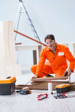 Contractor working on laminate wooden floorの写真素材