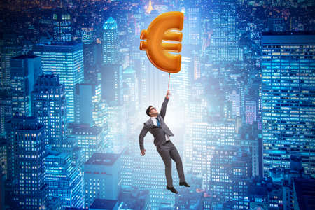 Businessman flying on euro sign inflatable balloonの写真素材