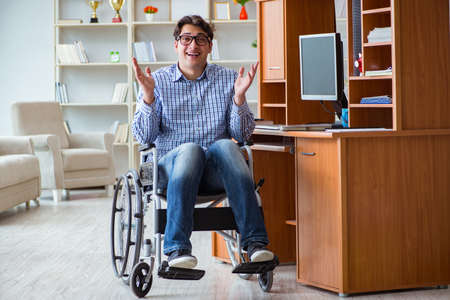Disabled student studying at home on wheelchairの写真素材