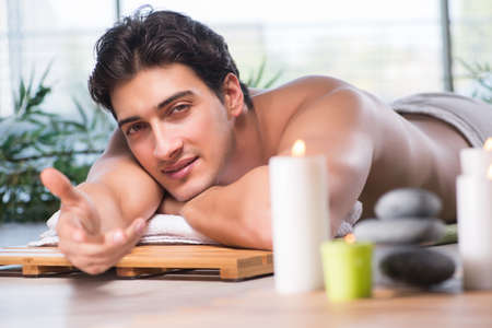 Young handsome man during spa procedureの写真素材