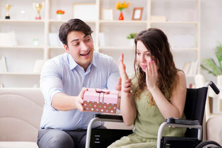 Man making marriage proposal to disabled woman on wheelchairの写真素材