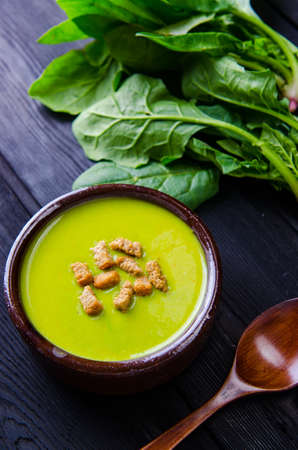 Spinach soup served on wooden board の写真素材