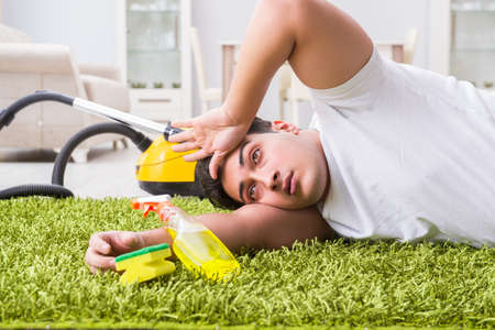 Young husband man cleaning floor at homeの写真素材