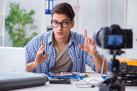 Vlogger recording computer repair on camera for vlog blogの写真素材