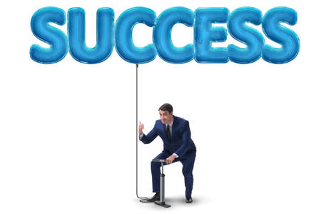Businessman pumping his success with air balloon on whiteの写真素材