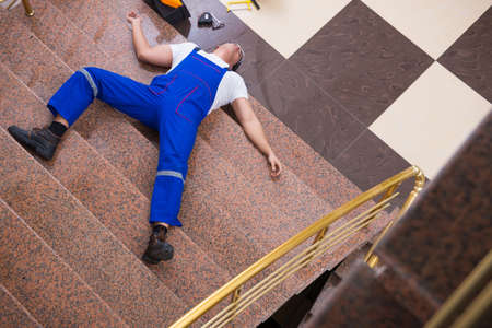 Dead contractor worker felling off the stairsの写真素材