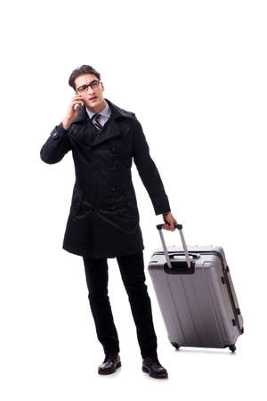 Young businessman with suitcase ready for business trip on whiteの写真素材