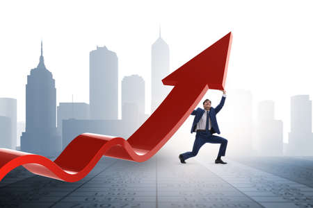 Businessman supporting growtn in economy on chart graphの写真素材