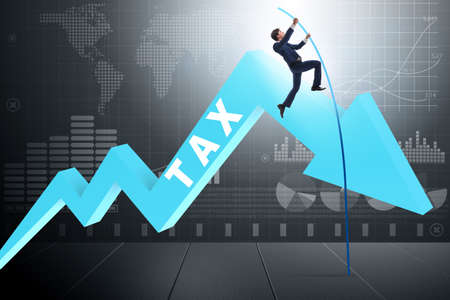 Businessman jumping over tax in tax evasion avoidance conceptの写真素材